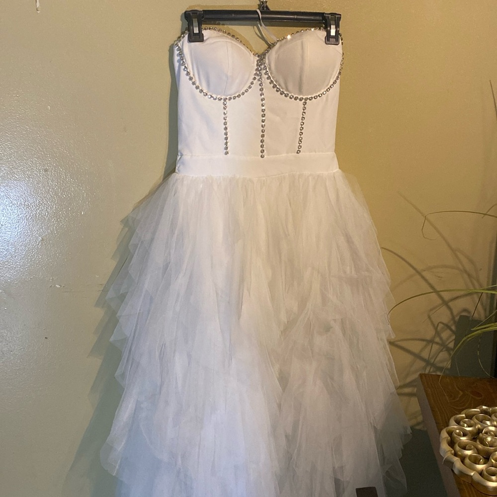White strapless corset top dress with gemstones, fluffy bottom.